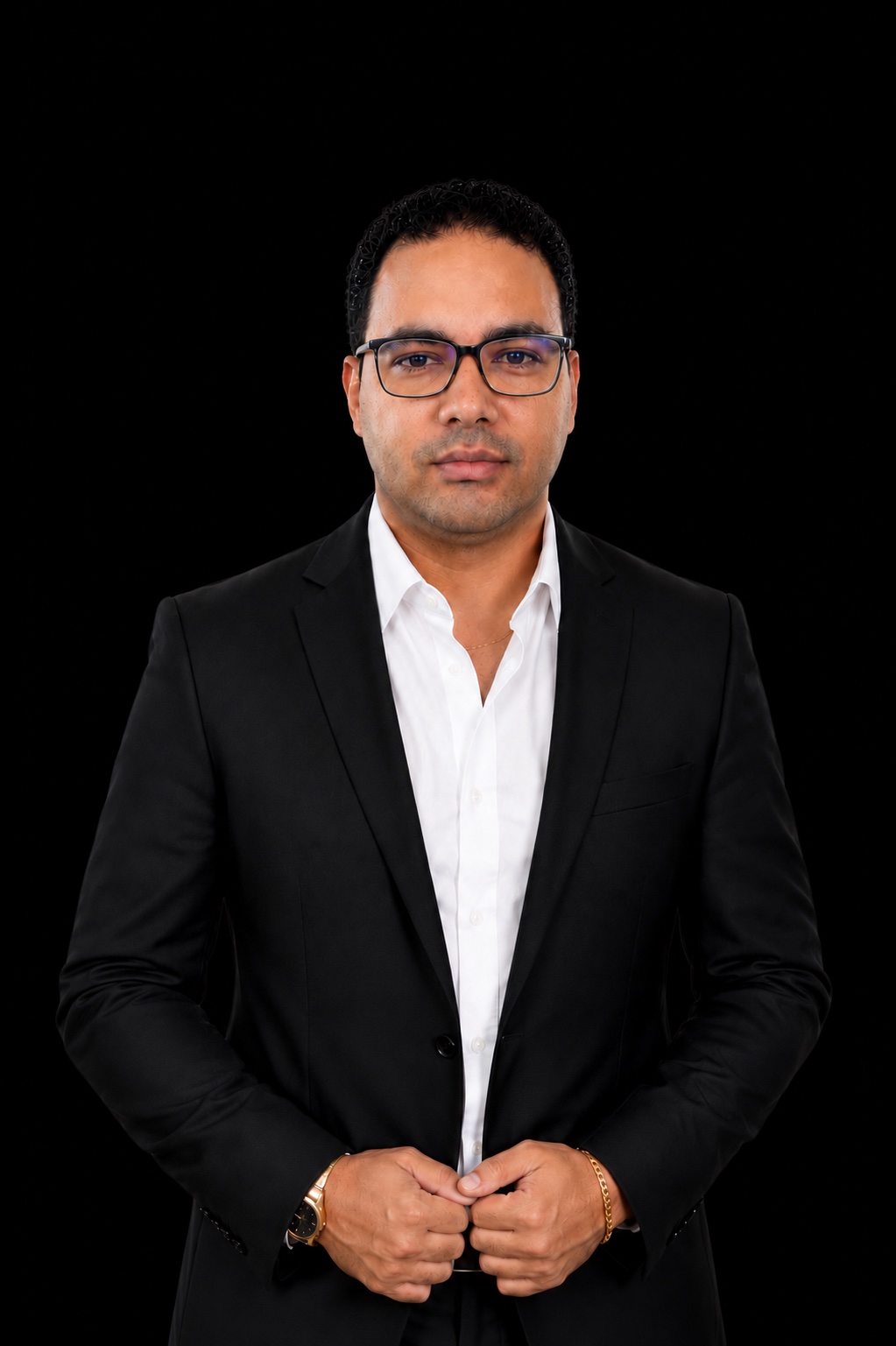 The person behind Trinprax, wearing glasses and a black suit